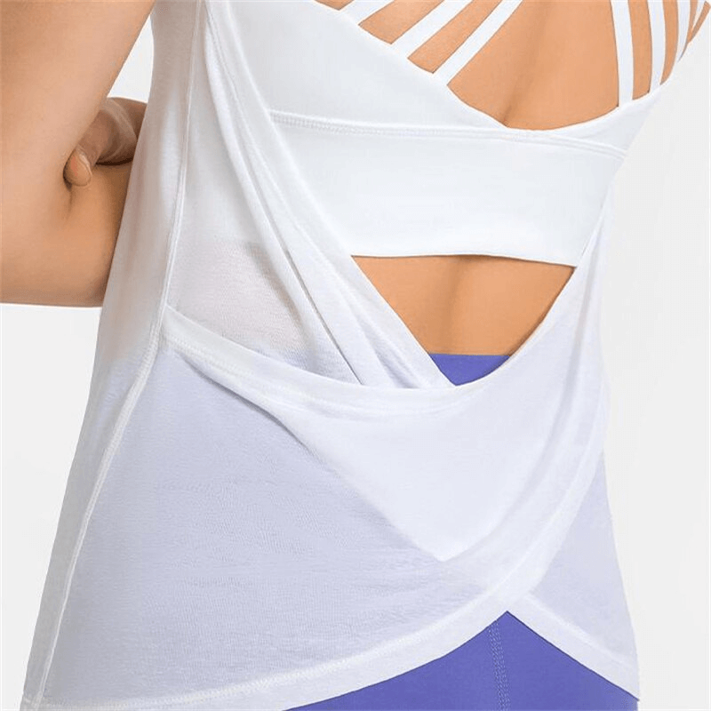 White sporty women's top with open back and cross straps, featuring breathable fabric ideal for yoga, running, and active wear.
